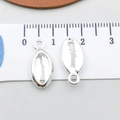 Silver alloy seashell charms for DIY jewelry making shown with metric scale ruler - Bright Silver Shell (20695)