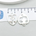 Macro view of silver alloy heart charms with rose relief and ruler showing size details - Hollow Rose (20445)