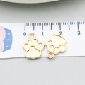 Detail shot of golden paw print charm pendants on a ruler showing 1.5cm size scale - KC Gold Dog Paw 12*15mm