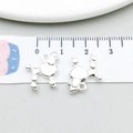 Macro shot of two silver dog charms on a measuring tape showing 1.5cm size - Bright Silver Fluffy Dog (20536)