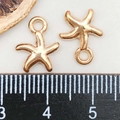 Macro shot of KC gold starfish charms showing 1.2cm size measurement on a ruler - Starfish Pendant (11594) / 10*13mm