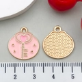 Macro detail of 20mm round pink enamel heart key charm with gold mesh texture back - Enamel Key (21115) / Pink