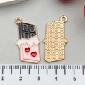Detail of red heart chocolate pendants showing front enamel and back honeycomb texture - Enamel Chocolate (21117) / Black
