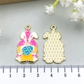 Detail of colorful Easter gnome enamel pendant with gold textured back and scale measurement - Pink Easter Gnome