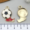 Detailed macro view showing soccer and cleat enamel charms alongside a ruler for size - White Enamel Football and Shoe