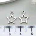 Detail view of silver star charms with a ruler showing approximately 1.2cm size - Hollow Pentagram Style (6915)
