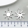Macro detail of sun-shaped antique silver charms showing textured front and grooved back - Sun Radiance Style (7699)