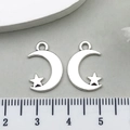Macro shot of silver crescent moon and star charms with ruler for size reference - Star and Moon Style (8519)