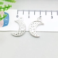 Macro shot of silver crescent moon charms with ruler showing 2cm size for DIY jewelry - Bright Silver Hollow Moon (20836)