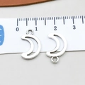 Silver crescent moon alloy charms shown on measuring tape for precise sizing - Antique Silver Hollow Moon (10942)