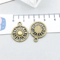 Detail of antique bronze sun pendant charm with hollow-out pattern and ruler for size scale - Antique Bronze Sun (8231)