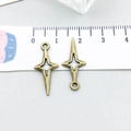 Bronze hollow star charms for jewelry making shown next to a measuring ruler - Antique Bronze Four-Pointed Star (20861)