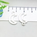 Bright silver alloy crescent moon pendants with scale for size reference - Bright Silver Hollow Moon (20851)
