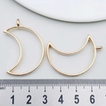 Macro shot of KC gold crescent moon pendant charms with ruler for size measurement - Moon Frame