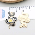 Halloween snake charms in black enamel and gold finish with sun and moon patterns - Black Enamel Sun Snake (18171)
