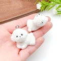 Close-up of small white flocked puppy charms for DIY jewelry making and necklaces - Bichon Puppy (22931) / White