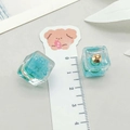 Detailed macro view of resin cube pendants with blue dried flowers and measurement scale - Blue-Green Resin Luminous Preserved Flower Cube