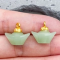 Detail of green glass sycee pendants with gold metal caps held for size reference - Light Green Lampwork Ingot (22204) / 15*14mm