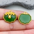 Golden green faux jade Ruyi lock pendants showing front and back details in hand - Green Lampwork Longevity Lock (22214) / 19*18mm