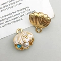 Detailed view of colorful enamel scallop charms with imitation pearls and rhinestones for DIY - White