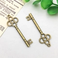 Detail of vintage bronze key pendants with floral openwork for DIY jewelry making - 15x47mm / Vintage Key Style (2319)