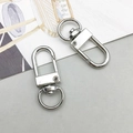 Close-up of two silver metal swivel lobster clasps for DIY jewelry and bag hardware - Lobster Clasp (12773) / 1 Piece (12x33mm) / White K Gold