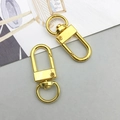 Detailed view of two gold metal lobster clasps with swivel rings for DIY jewelry projects - Lobster Clasp (12776) / 1 Piece (12x33mm) / Gold