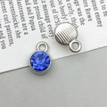 Detailed view of silver alloy star pendant showing blue crystal front and textured back - Silver December Style (13504)
