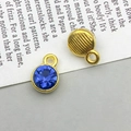 Detailed macro view of front and back of round blue rhinestone pendant for DIY jewelry - December - Sky Blue