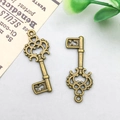 Vintage bronze alloy key charms with intricate heart scrollwork for DIY jewelry - 12x28mm / Vintage Key Style (788)