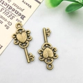 Antique bronze heart-shaped alloy key pendant with intricate vintage hollow design - 13x37mm / Vintage Key Style (1485)