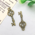 Pair of antique bronze alloy key pendants with heart cutout for DIY jewelry - 10x27mm / Vintage Mini Key Style (1611)