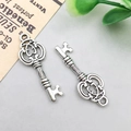Antique silver finish vintage key pendant with intricate hollow pattern and aged metal texture - 10x27mm / Vintage Mini Key Style (3112)