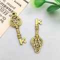 Antique gold alloy key pendant with heart-shaped cutout and vintage texture details - 27x10mm / Antique Gold Vintage Key Style (11370)
