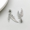 Macro view of vintage silver alloy wing charms with detailed feather texture for DIY jewelry - Double Wings Style (11467)