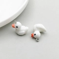 Two cream-colored resin duck charms with silver rings for DIY jewelry making - White