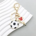 Golden football keychain variant with red jersey player and black white ball pendant - Football Player Style (ER769)