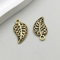 Pair of antique gold alloy leaf pendants with intricate filigree texture for DIY jewelry - Antique Gold Leaf (10093)