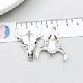 Macro detail of vintage silver bull skull charms showing textured finish and loop - Antique Silver Smooth Bull Head (18711)