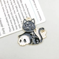 Enamel black cat and skull charm pendant with golden moon and star details - Black Cat Sitting on Skull (18143)