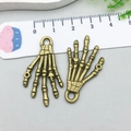 Detail of vintage bronze skeleton hand charms for DIY jewelry and Halloween crafts - Skeleton Hand (5712)