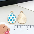 Front and back detail of enamel Easter egg pendant with blue dots and sunburst texture - Blue White Polka Dot Egg (15143)