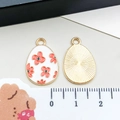 Detail of Easter egg charm with white enamel flower pattern and measurement scale - White Red Flower Egg (15141)