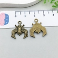 Antique bronze bat charms for DIY jewelry making shown with a measuring ruler - Bat (1480)