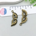 Pair of vintage bronze Venetian mask alloy charms for DIY Halloween jewelry making - Mask (1620)