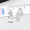 Silver snowman pendant for DIY jewelry making shown with metric measurement ruler - Christmas Snowman (8843) / 12*24mm