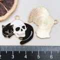 Detail of Halloween cat and skull charms with size reference on a scale - Black Skull Cat Style (18125)