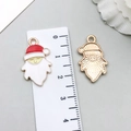 Detail of Santa Claus enamel pendants showing front and textured gold back with a ruler - Red and White Santa Head (15550)