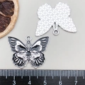 Measurement of black butterfly pendant with skull design showing 4cm width on ruler - Black Skull Butterfly (19383)
