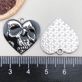 Detail view of heart-shaped black enamel skull pendant with measurement scale - Black Heart Skull (19384)